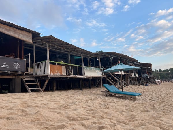 Lazy beach morning in Kuta Selatan, surf, sand, and golden skies