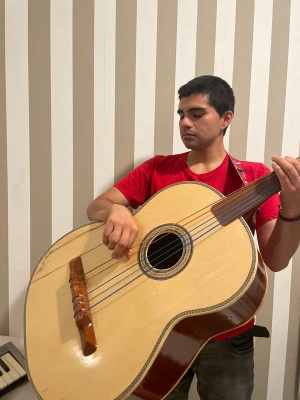 Young musician plays multiple instruments in Spanish coastal bedroom
