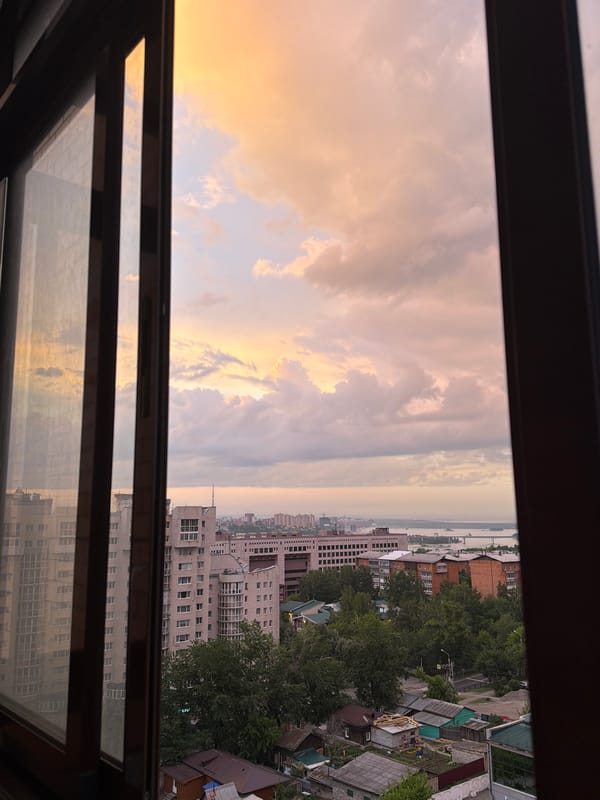 Irkutsk skyline at golden hour, dramatic clouds overhead