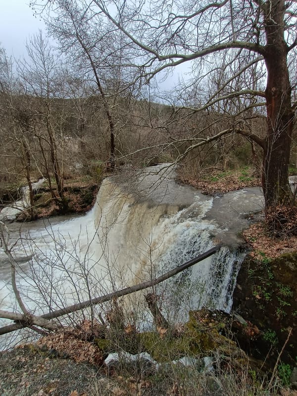 Spring waterfall documented in Parvenets, Bulgaria shows muddy conditions