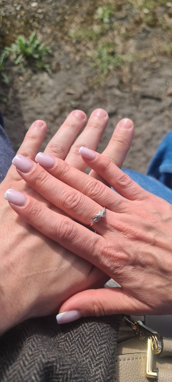 Couple shares tender moment under cloudy Riga skies