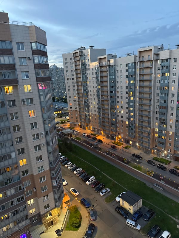 Russian city skyline at dusk, tower and apartments at sunset