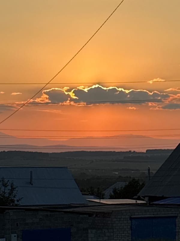 Vivid summer sunset over a neighborhood, power lines and all