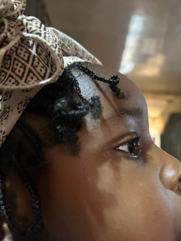 Person with braids resting in Jos, Nigeria morning