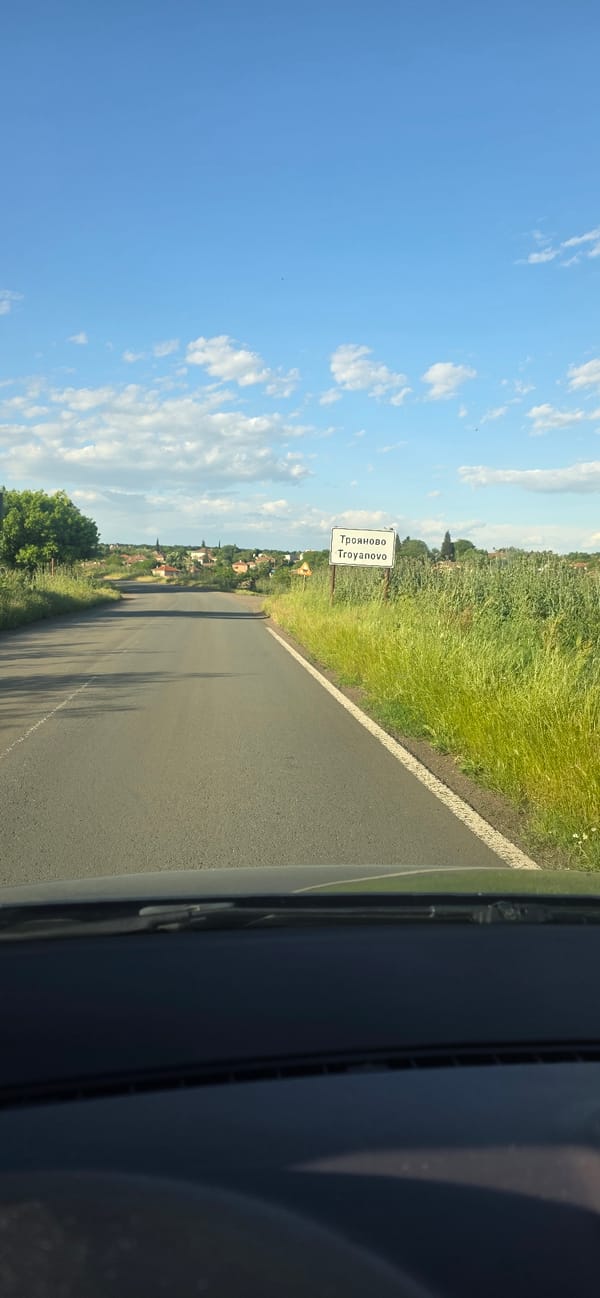 Driver passes through Troyanovo, Bulgaria entrance on sunny afternoon