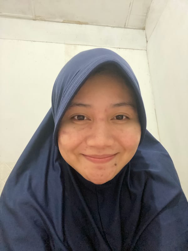 Indoor selfie session with skincare and a drink in Banjarbaru