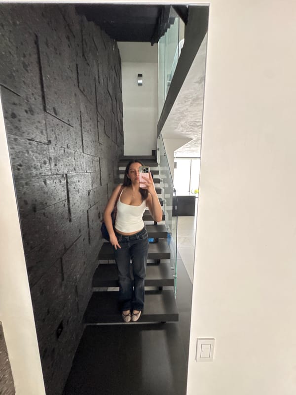 Woman takes mirror selfie in Puebla building