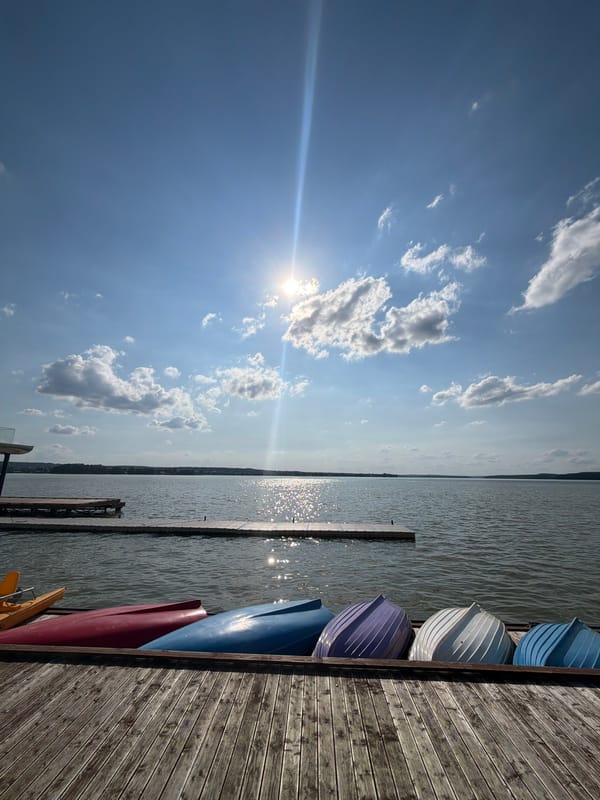 Canoes and pedal boats docked on a sunny Votkinsk lake