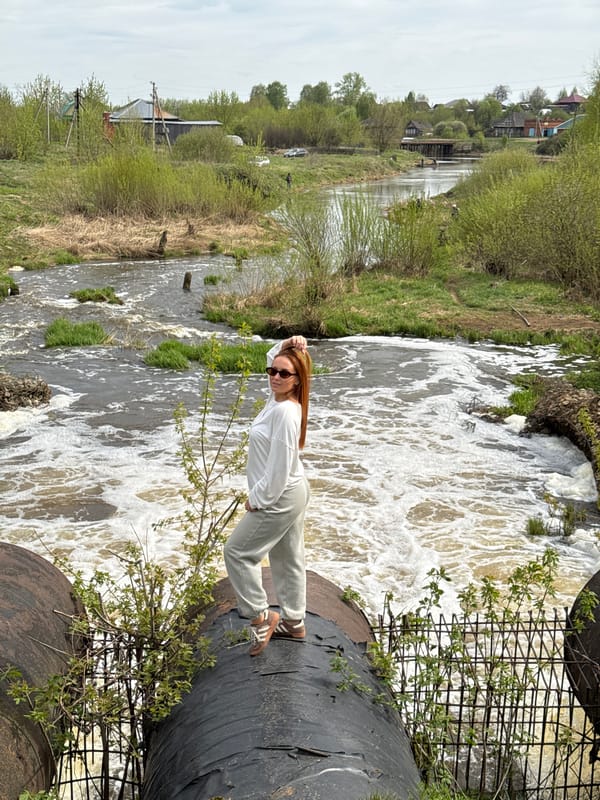 Woman photographed on dam walkway in Nozhovka, Russia