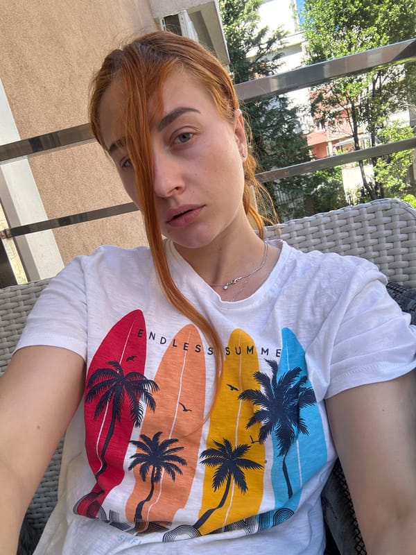 Woman enjoys morning balcony time in Budva, Montenegro