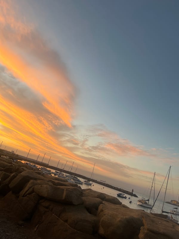 Vibrant sunset illuminates Arica marina with orange clouds