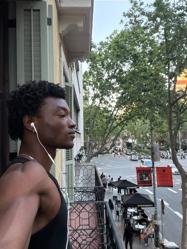 Man with earphones spotted on Barcelona street from balcony view