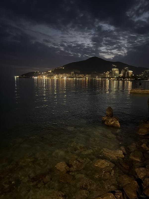 Man cleans sailboat, relaxes by waterfront in Budva