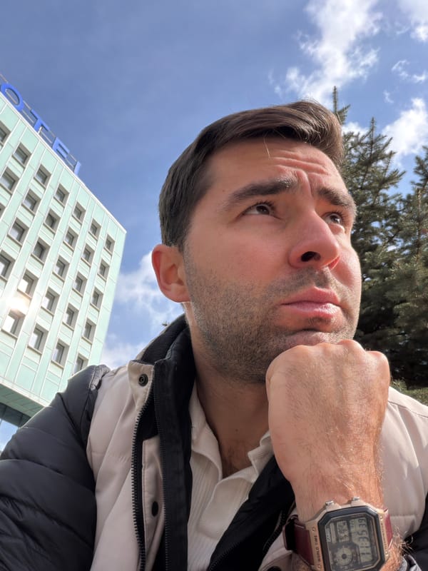 Man takes contemplative selfies near lion statue in Krasnoyarsk