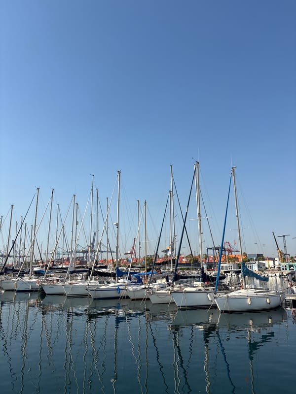 Coffee and sailboats at Valencia's marina on a clear morning
