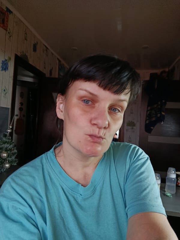 Woman poses playfully for indoor portrait in Foki, Russia