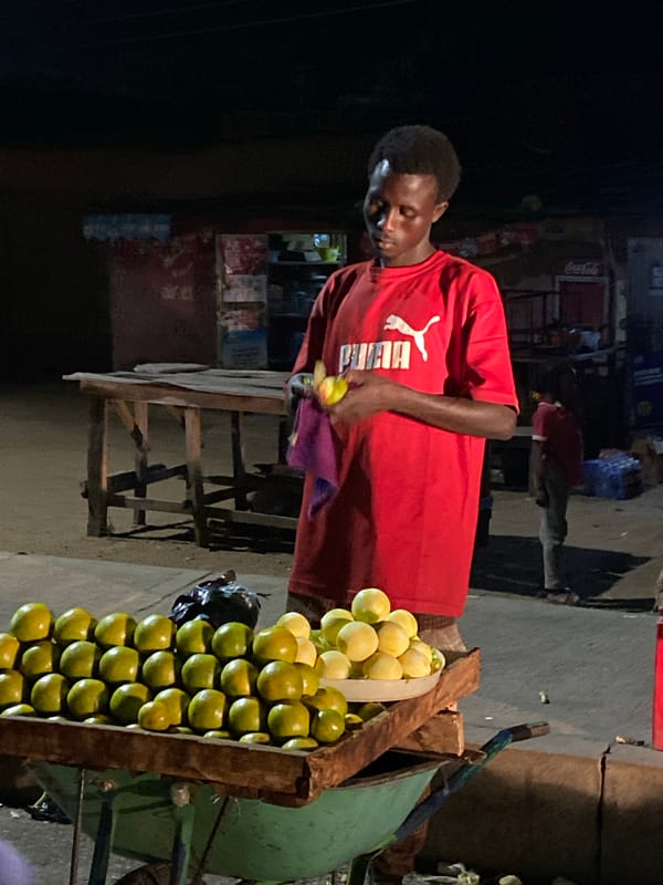 Night market bustles with fruit vendors in Bukuru, Nigeria