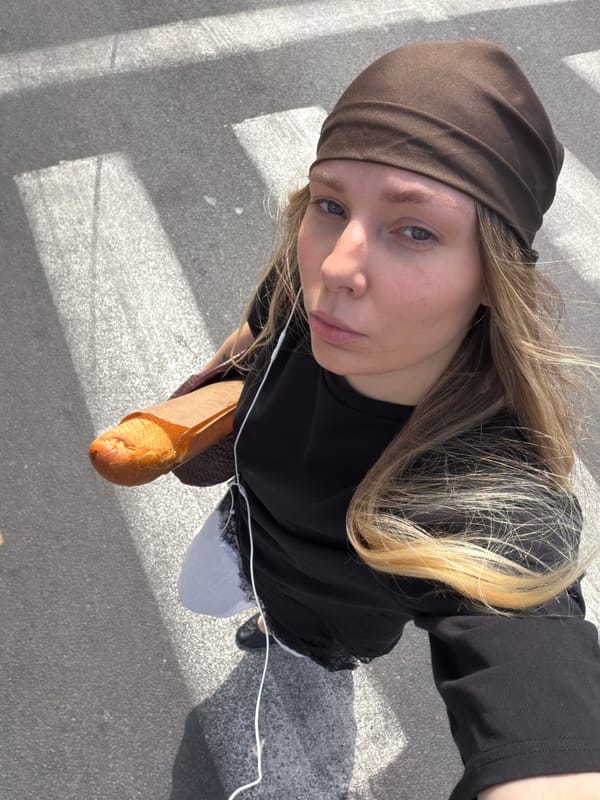 Woman with baguette crosses Tel Aviv street Monday morning