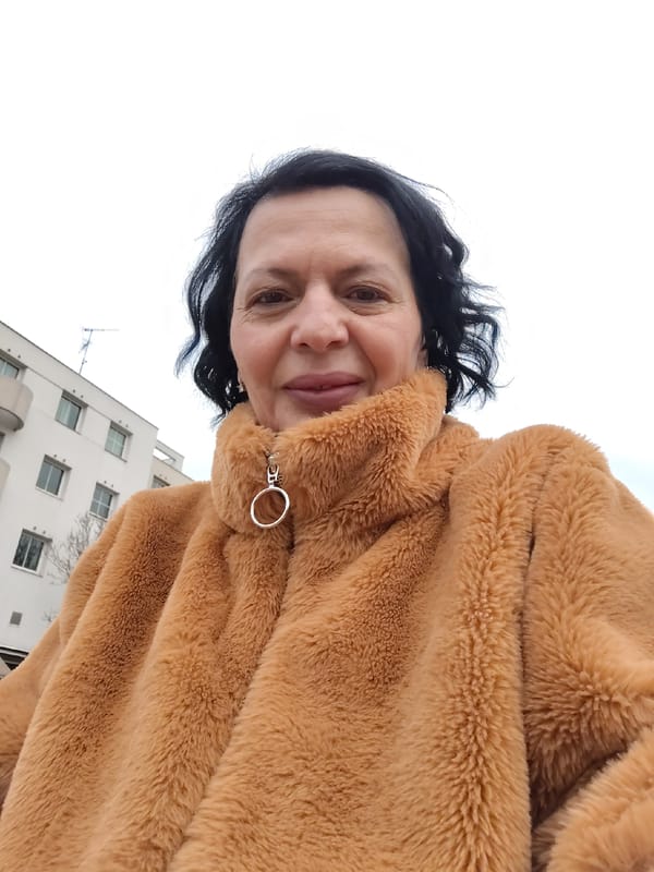 Woman takes selfie in brown jacket near Strasbourg