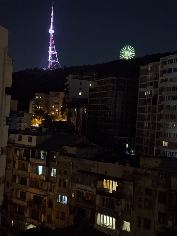 Tbilisi TV Tower glows pink over the nighttime skyline
