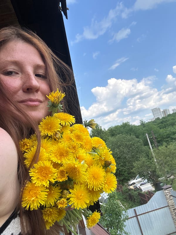 Woman poses with dandelion bouquet on Nizhny Novgorod balcony