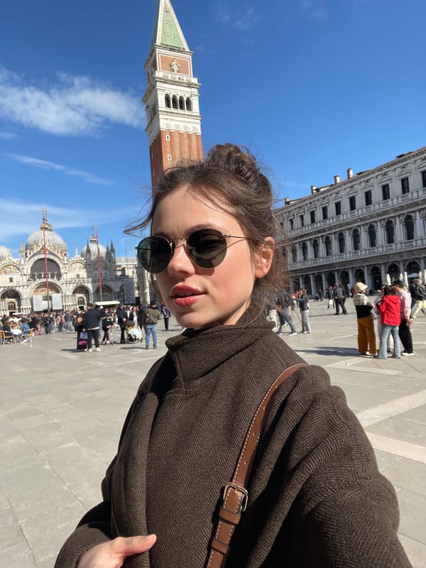 Tourists photograph St. Mark's Square landmarks in Venice