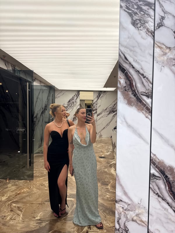 Two women take selfie at mirrored wall in Israel