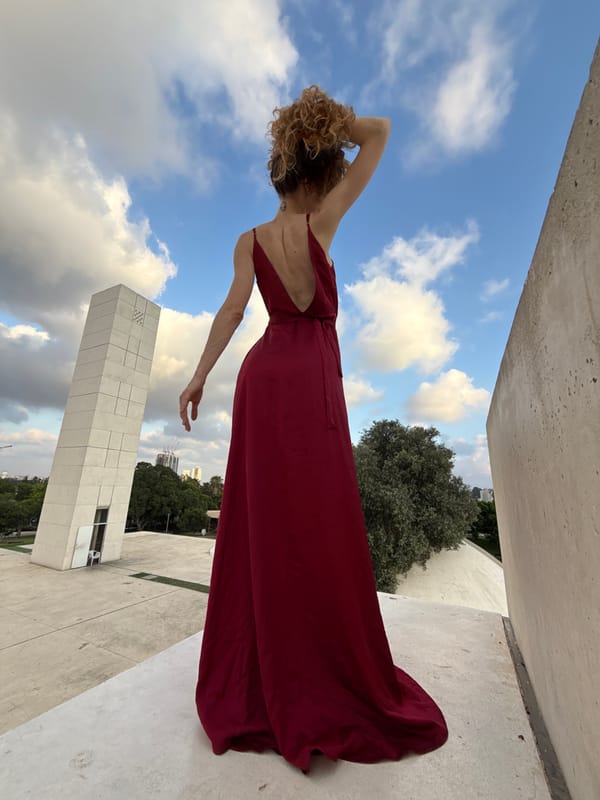 Dark red dress, Tel Aviv rooftop, summer afternoon.