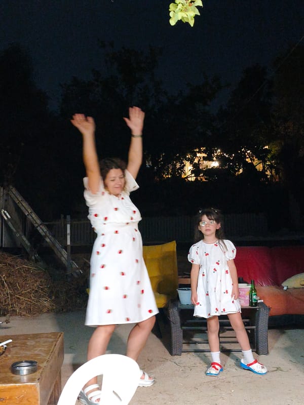 Nighttime backyard dancing in matching strawberry dresses, Lachish