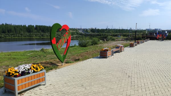 Strolling Mirny's riverside promenade on a summer morning