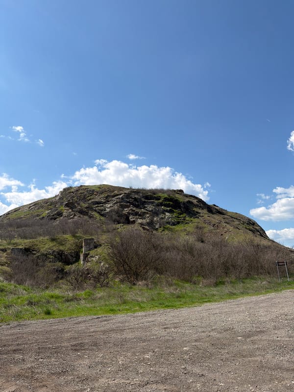 Rocky hillside documented near Rusokastro, Bulgaria under partly cloudy skies