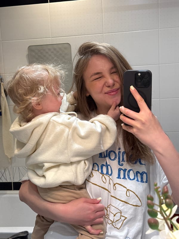 Mother takes bathroom selfie while holding baby in Vladimir