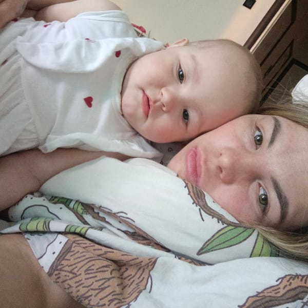 Mother and baby share quiet morning moments in bed