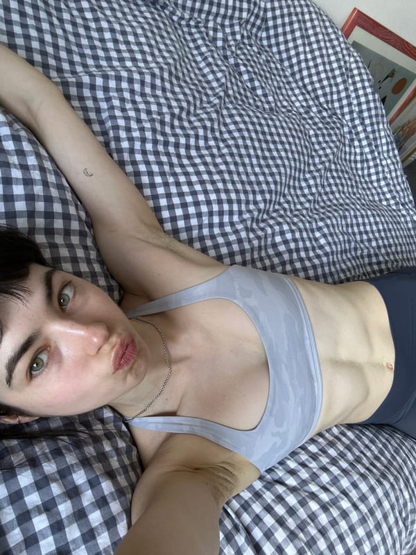 Person resting on bed observed in London residential setting