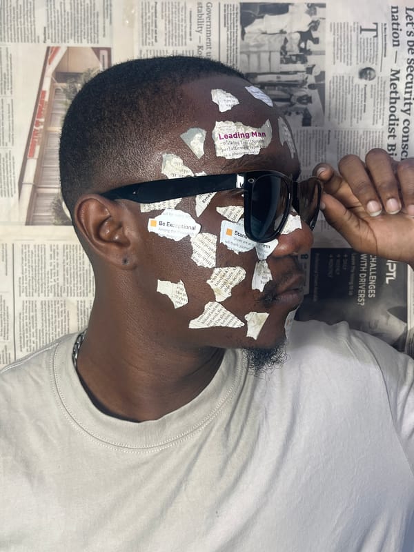 Man rests on newspaper-covered surface in Joma, Ghana