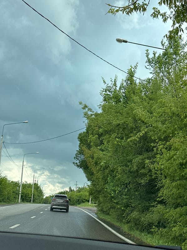 Wet roads and dramatic skies on a cloudy rural drive