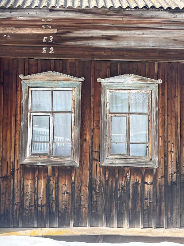 Wooden building with decorated windows documented in rural Russia