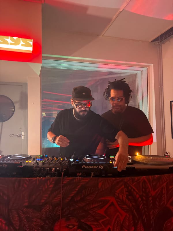 Two men operate DJ setup in Barcelona