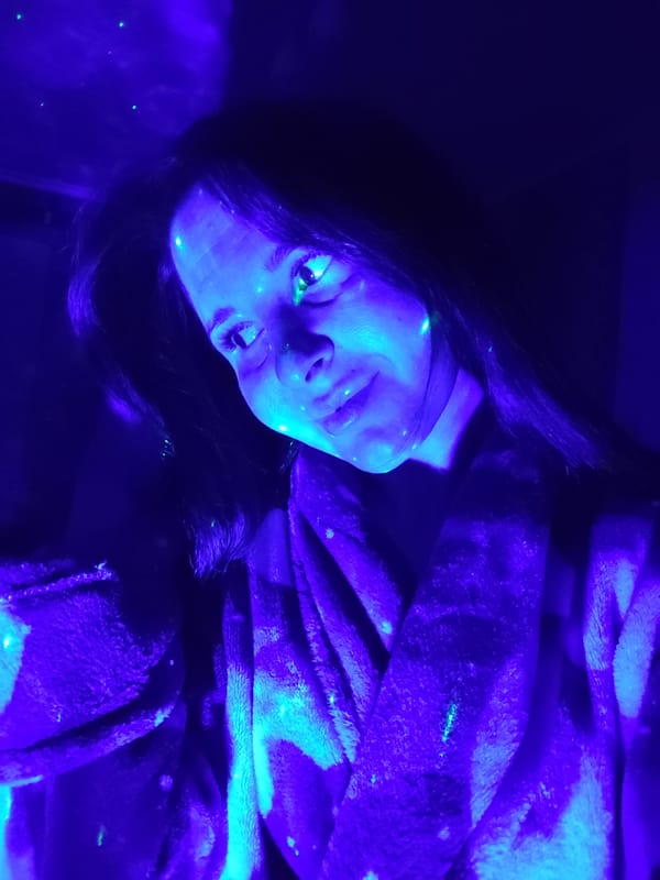 Woman illuminated by blue light in Russian town