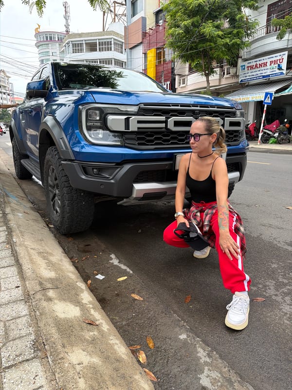 Blue Ford Raptor parked on Nha Trang's coastal strip amid city traffic