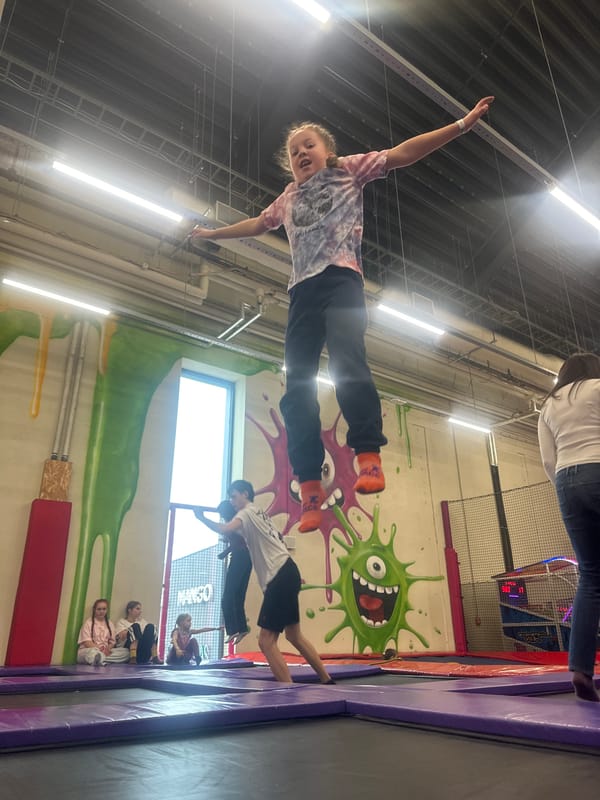 Child plays on indoor swing in Rīga