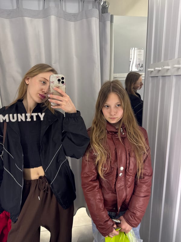 Friends take selfies in Russian clothing store fitting room