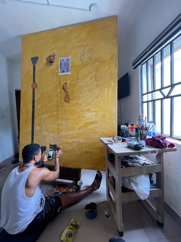 Artist creates large canvas painting in Ado studio