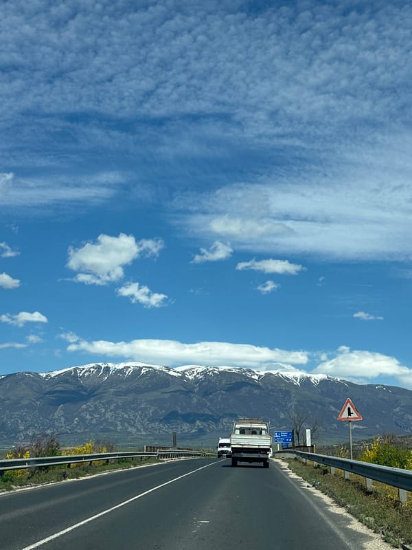 White truck travels mountain highway near Banya, Bulgaria