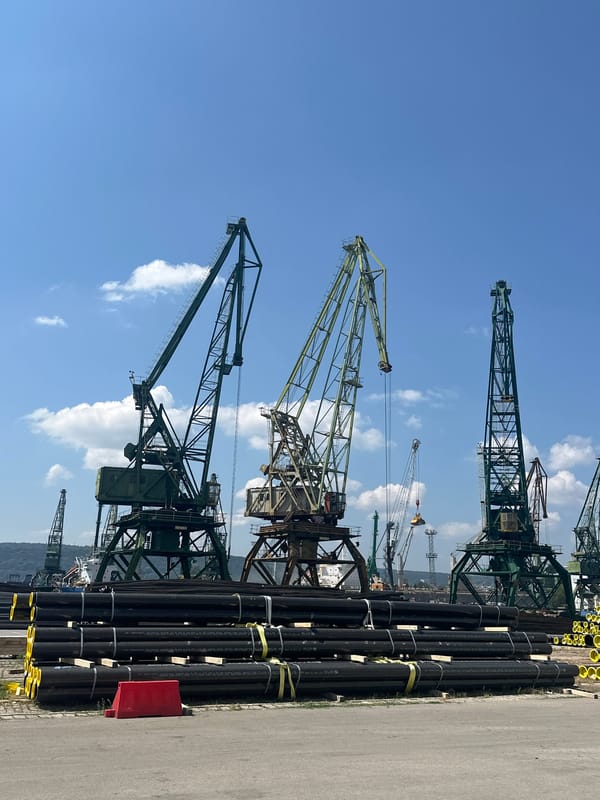 Port operations and cranes at a sunny industrial harbor