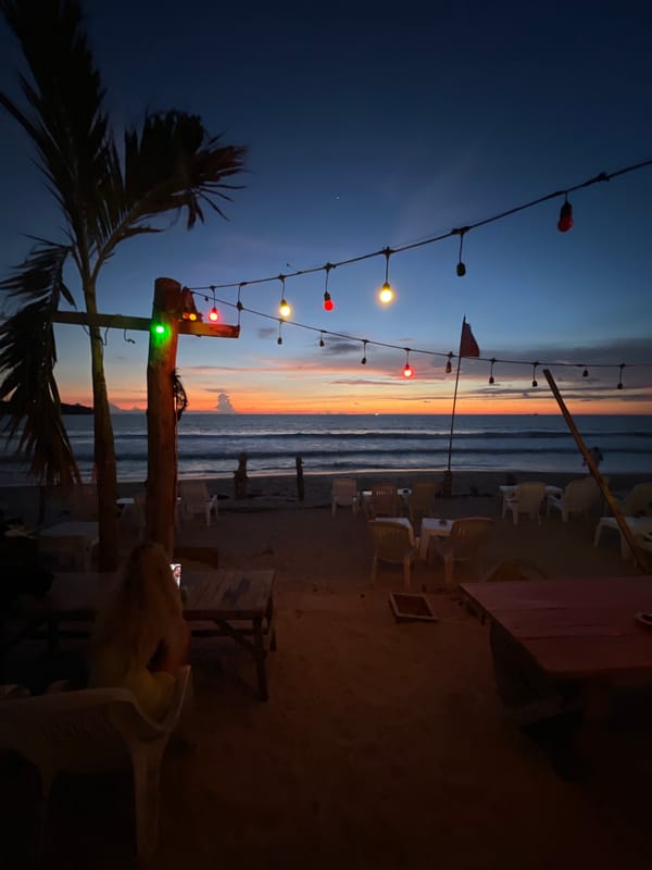 Fire performers spell "NOMAD" in flames at beach restaurant