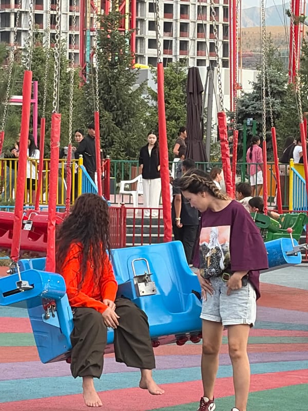 Busy afternoon at an amusement park as the sun goes down