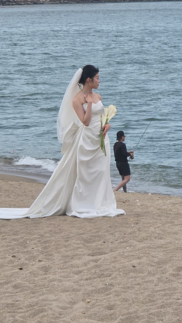 Beach wedding shoot in Nha Trang under a dramatic stormy sky