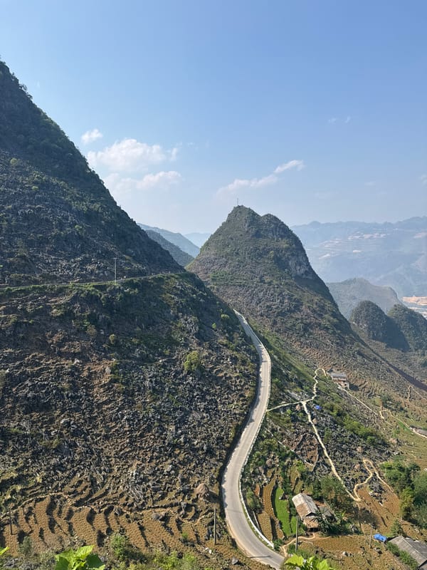 Tourist photographs mountain road and terraces in northern Vietnam