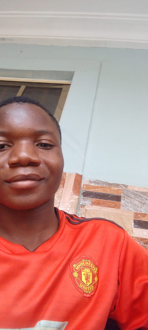 Person in Manchester United jersey observed indoors